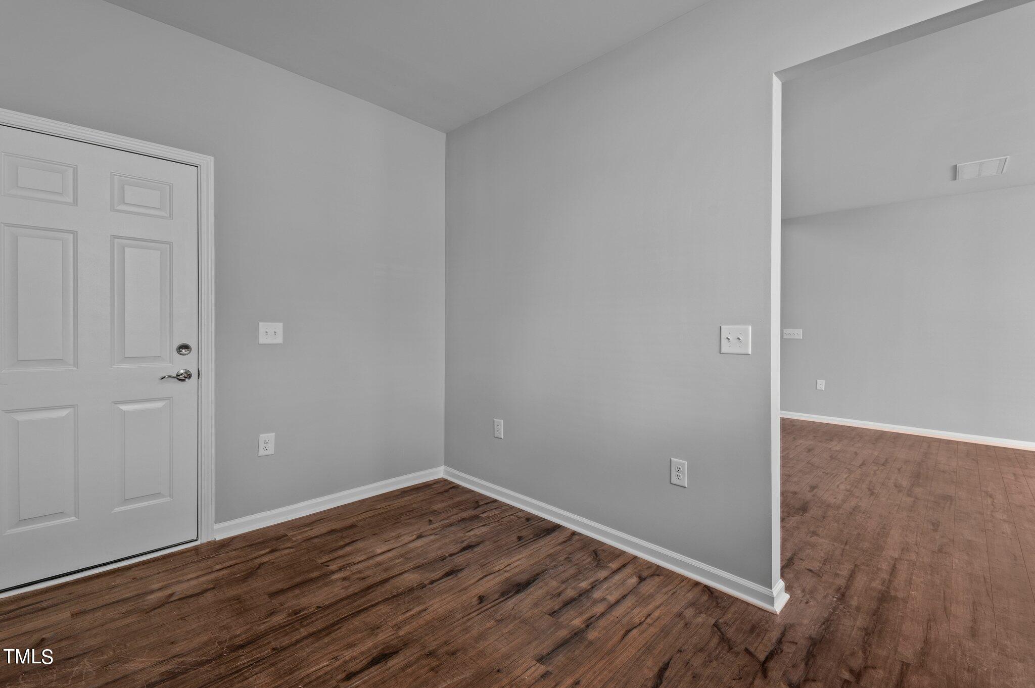 1033 Mirbeck Lane Durham, NC 27713 - Photo 12 of 37 a view of an empty room with wooden floor