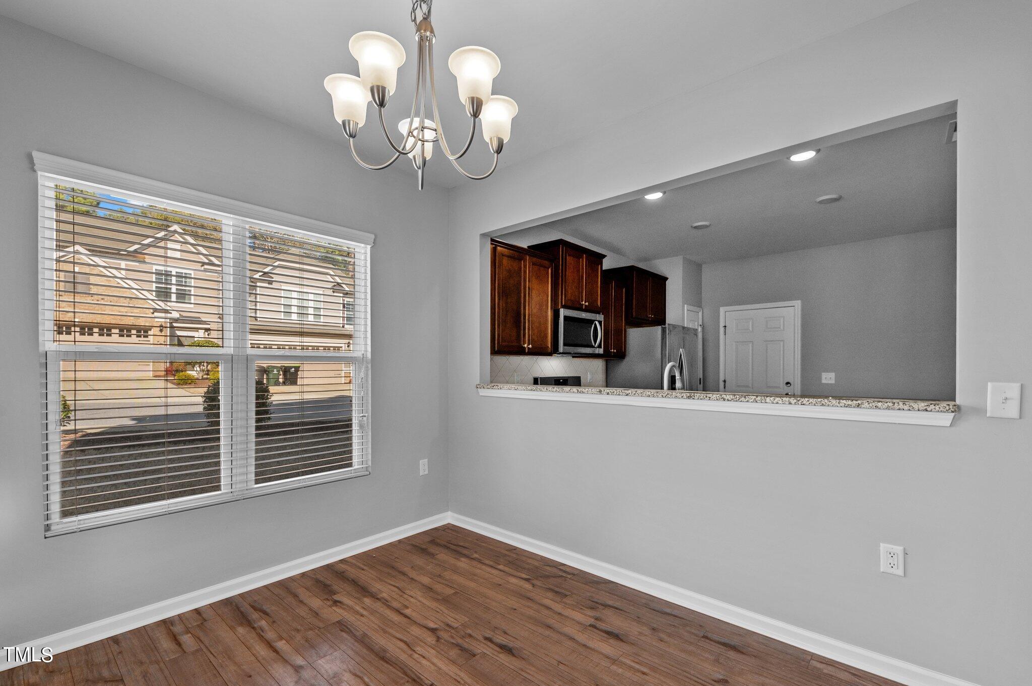 1033 Mirbeck Lane Durham, NC 27713 - Photo 16 of 37 a view of kitchen with kitchen island wooden floor and window