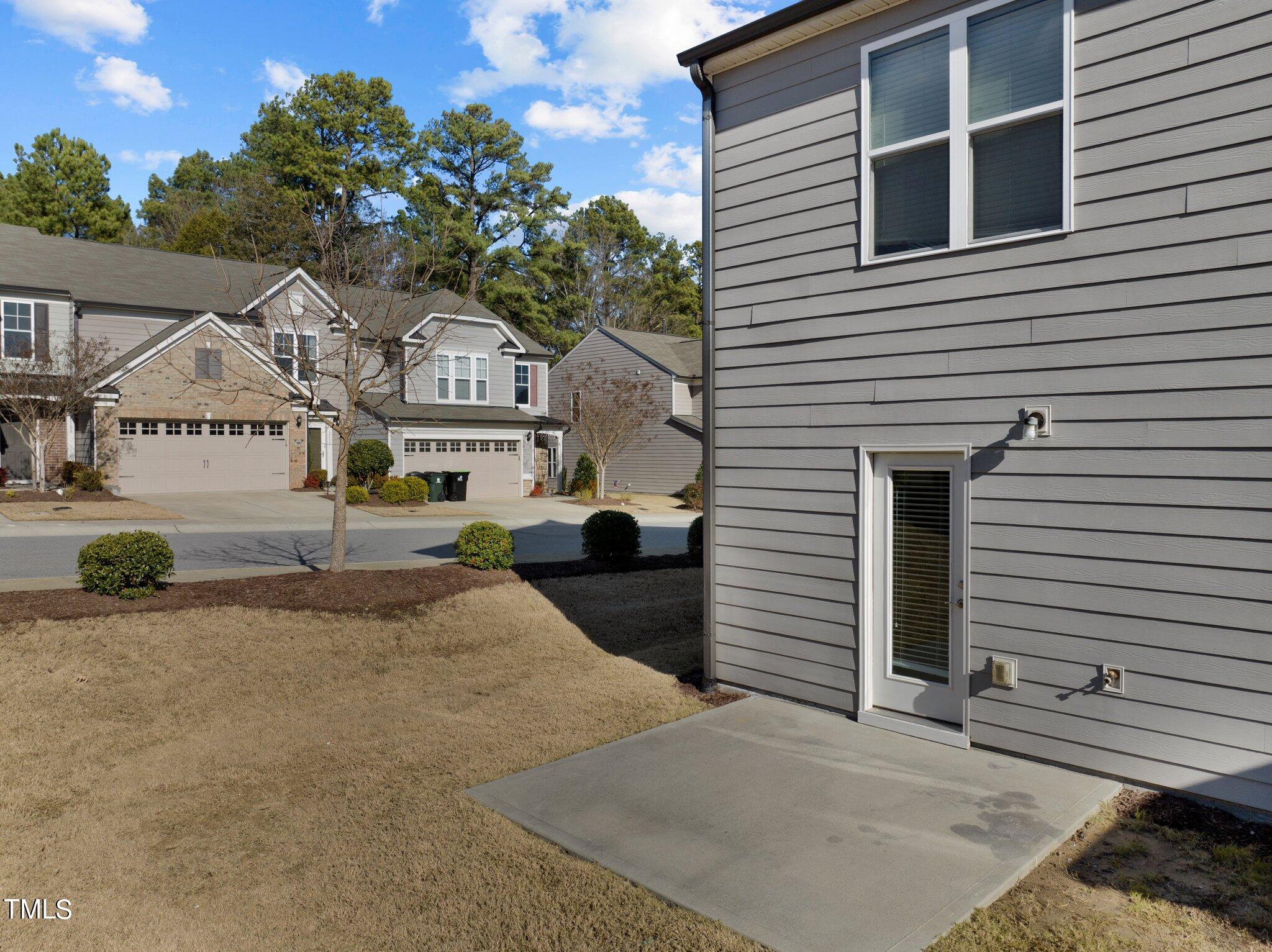 1033 Mirbeck Lane Durham, NC 27713 - Photo 35 of 37 a front view of a house with a yard and garage