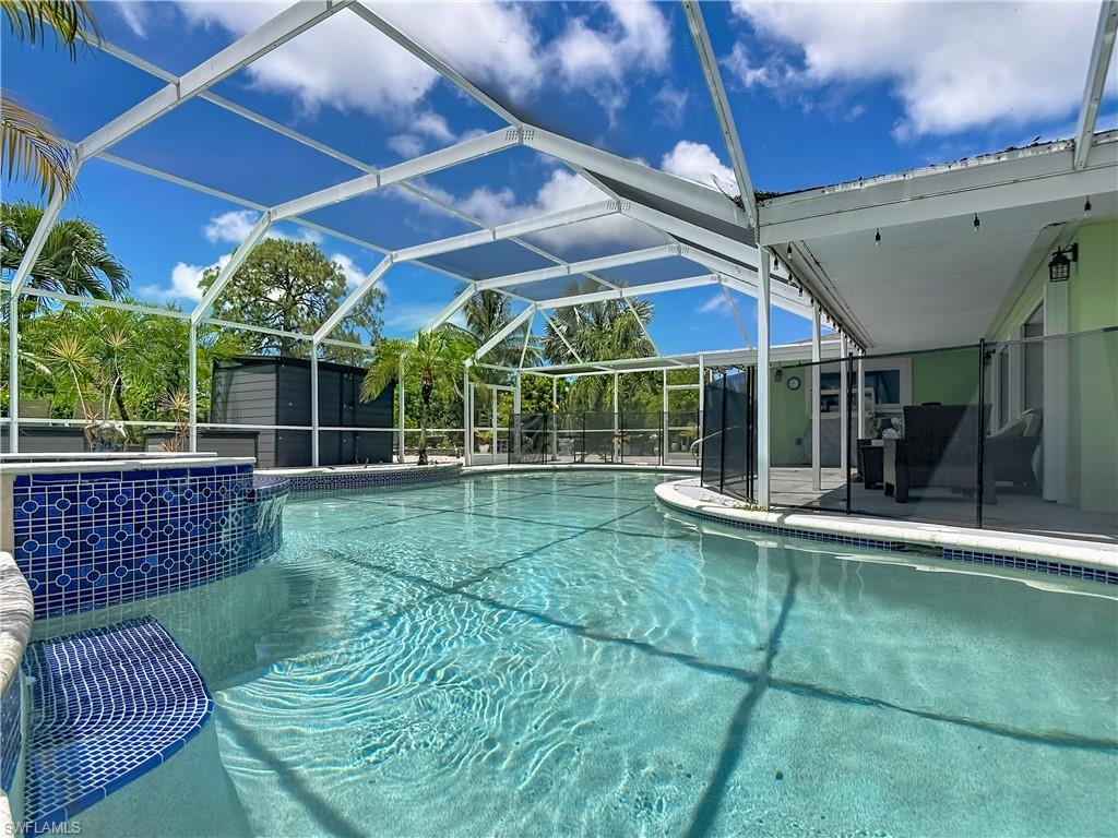 2280 Capri Court Naples, FL 34105 - Photo 35 of 49 a view of a backyard with floor to ceiling window and wooden fence