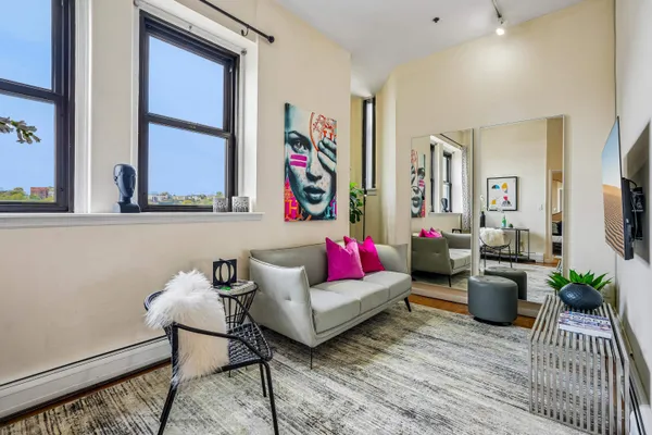 a living room with furniture and a potted plant