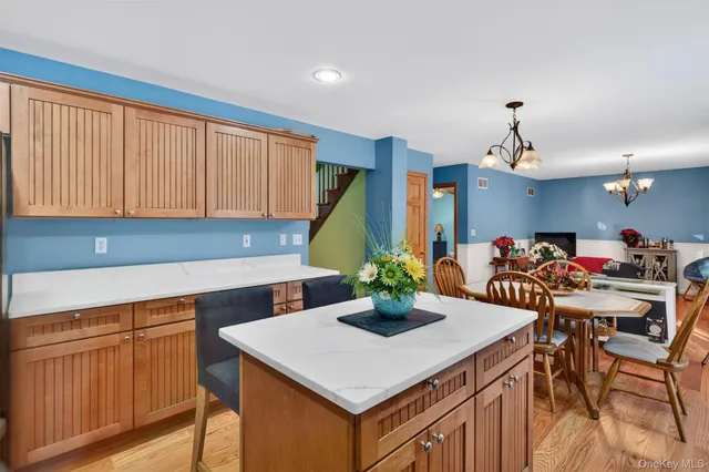 a kitchen with a table chairs and white cabinets