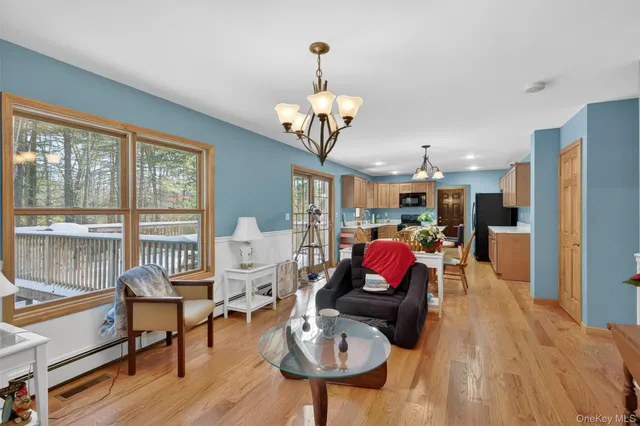 a living room with furniture fireplace and large windows
