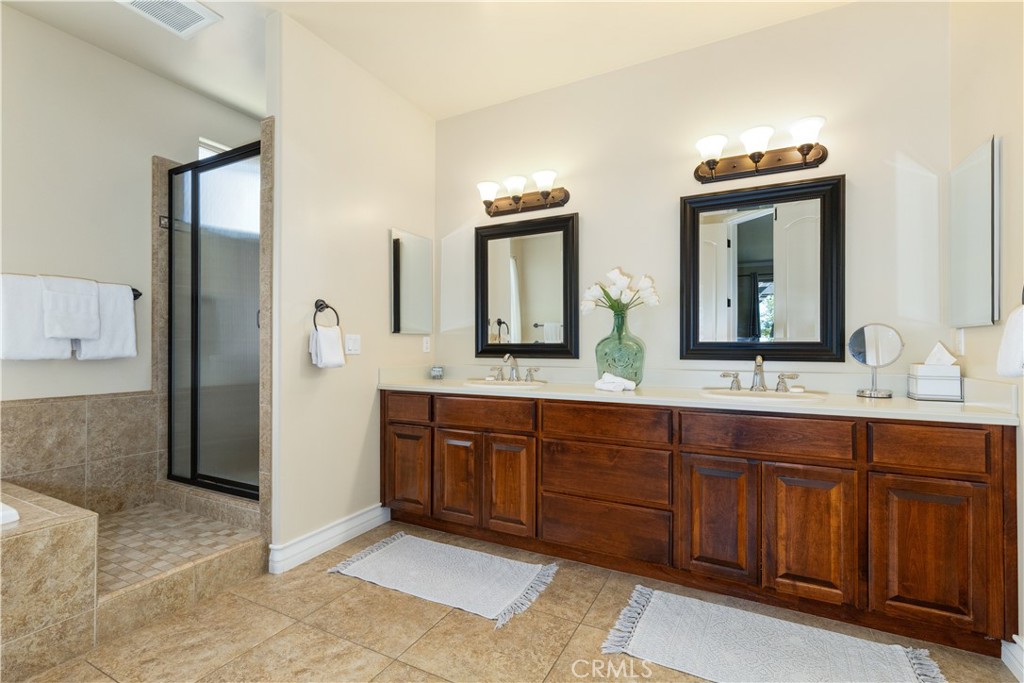 669 Red Cloud Road Paso Robles, CA 93446 - Photo 22 of 61 a spacious bathroom with double vanity and a mirror