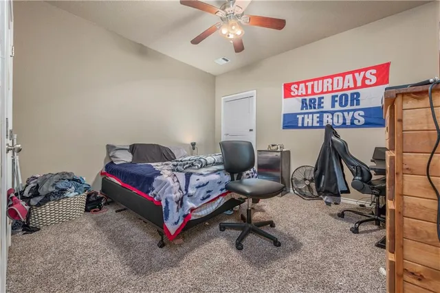 a bathroom with a granite countertop sink toilet and mirror