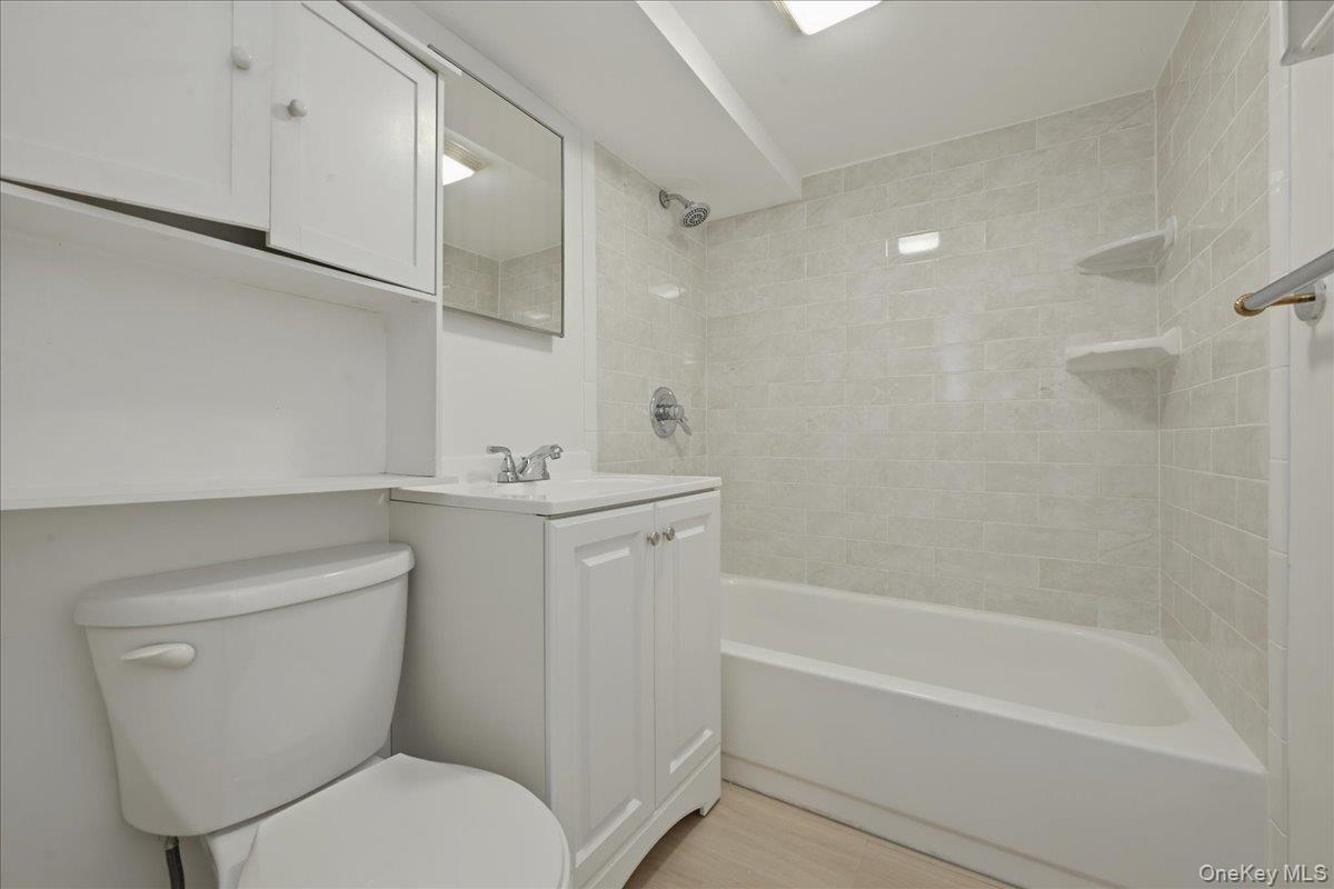 17 Avon Road Farmingdale, NY 11735 - Photo 33 of 46 a bathroom with a toilet sink and bathtub