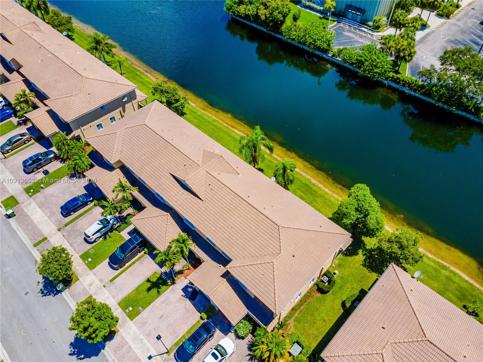 5904 Abbey Road, Unit 5904 Tamarac, FL 33321 - Photo 3 of 40 an aerial view of a house with a garden and lake view