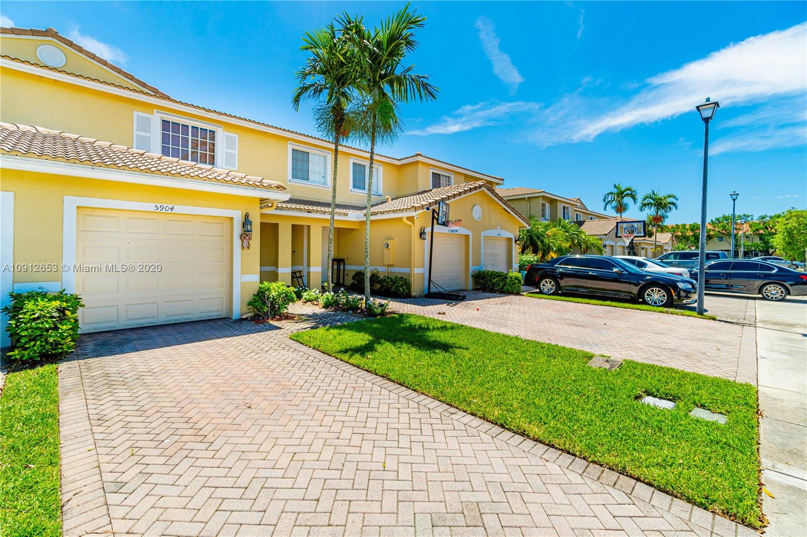 5904 Abbey Road, Unit 5904 Tamarac, FL 33321 - Photo 4 of 40 a front view of a house with a yard