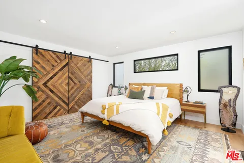 a bedroom with a bed and a couch