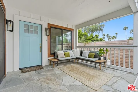 a building outdoor space with patio furniture and potted plants