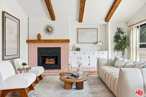 a living room with furniture a window and a fireplace