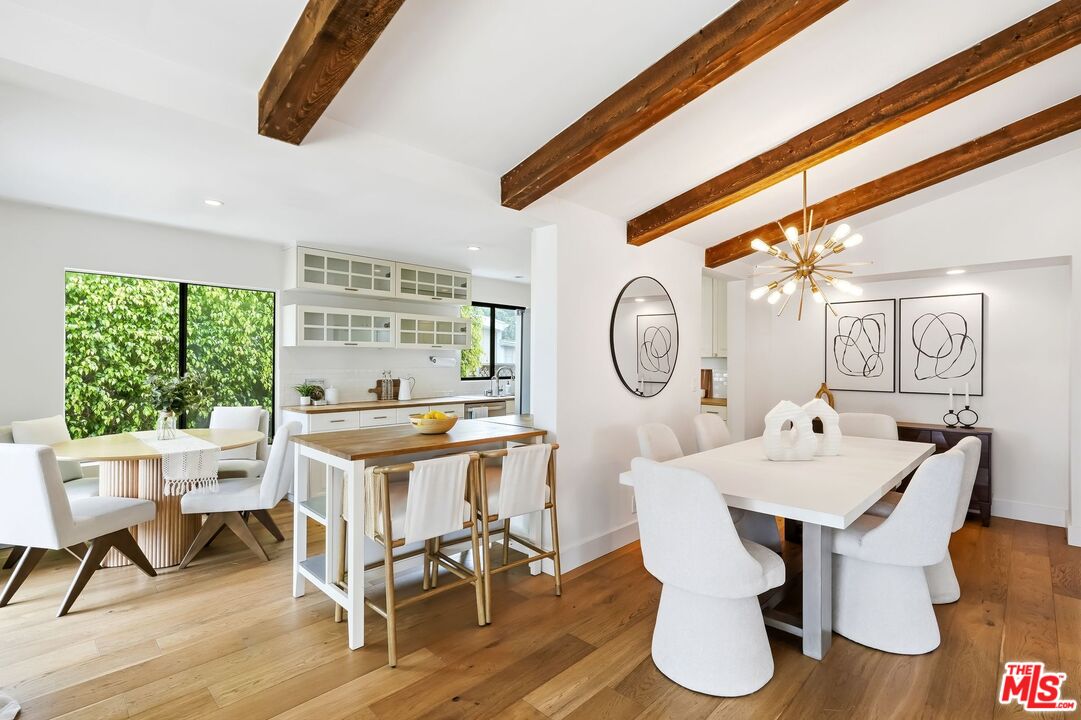 29500 Heathercliff Road, Unit 294 Malibu, CA 90265 - Photo 25 of 35 a view of a dining room with furniture window and wooden floor