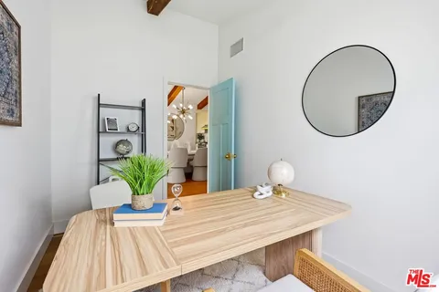 a bedroom with a bed and a potted plant