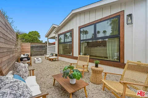 a backyard of a house with outdoor seating
