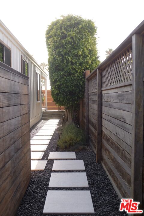 29500 Heathercliff Road, Unit 294 Malibu, CA 90265 - Photo 4 of 23 a view of a pathway with a house