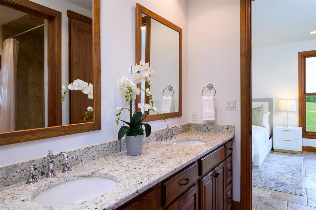 11503 East Rocky Creek Road Crowley, TX 76036 - Photo 23 of 40 a bathroom with a granite countertop sink and a mirror
