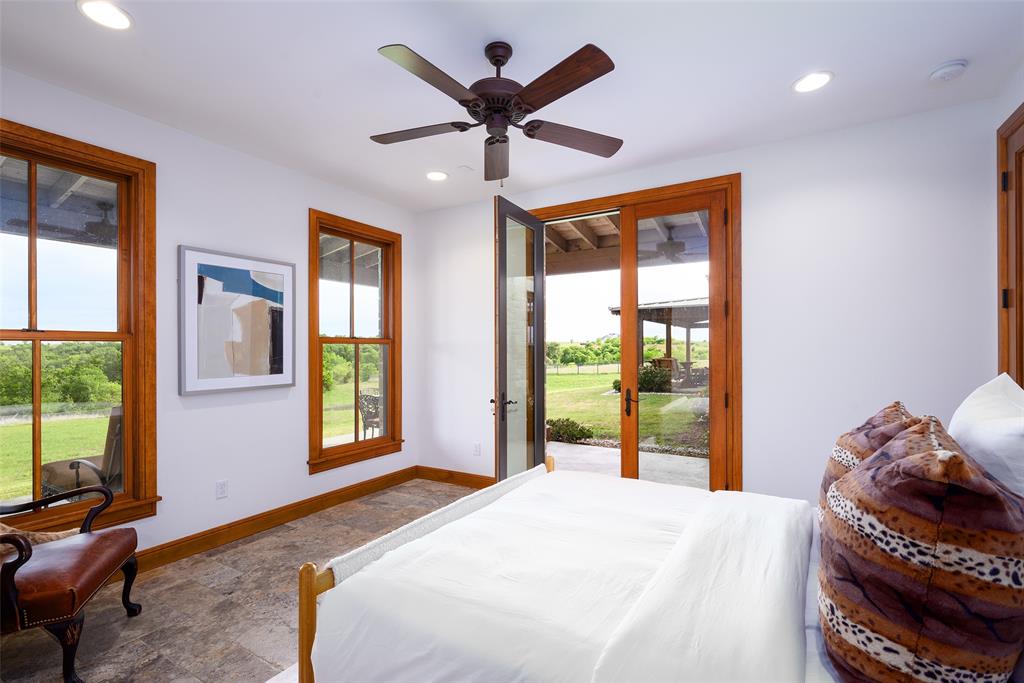 11503 East Rocky Creek Road Crowley, TX 76036 - Photo 24 of 40 a bedroom with a bed and glass walk in closet