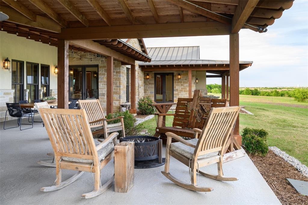 11503 East Rocky Creek Road Crowley, TX 76036 - Photo 30 of 40 a view of a patio with a dining table and chairs with wooden floor