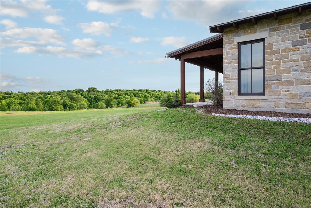 11503 East Rocky Creek Road Crowley, TX 76036 - Photo 39 of 40 a view of a backyard with plants and large tree