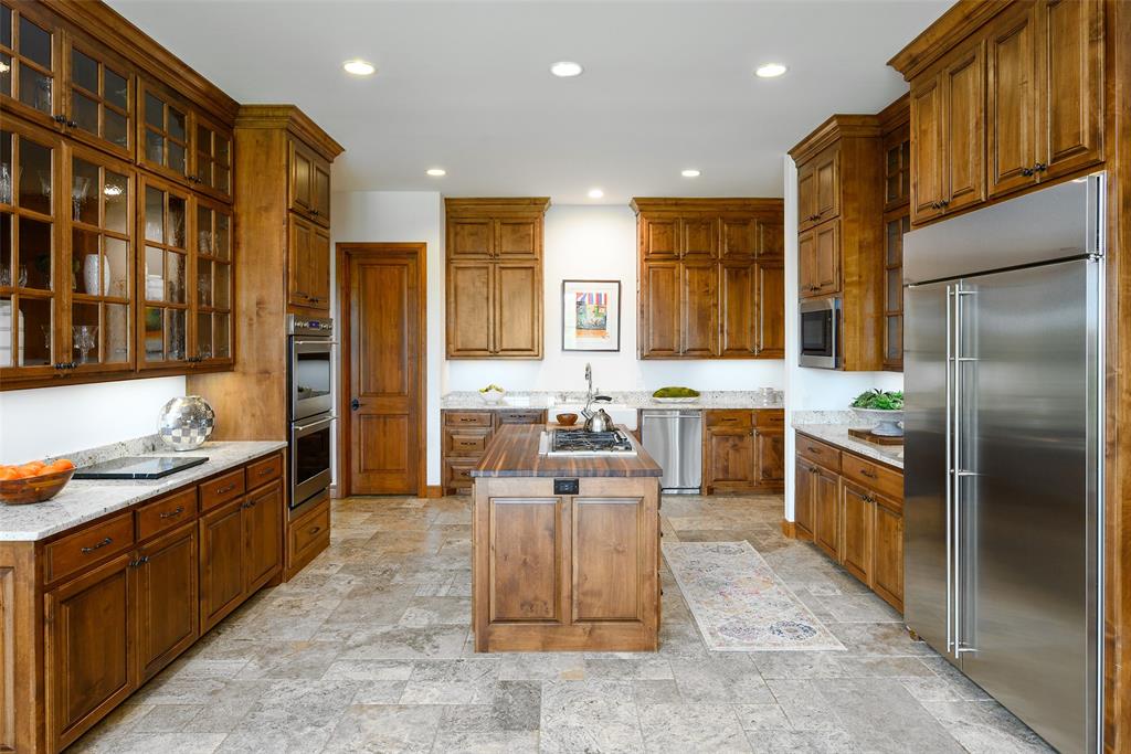 11503 East Rocky Creek Road Crowley, TX 76036 - Photo 10 of 40 a large kitchen with stainless steel appliances kitchen island granite countertop a large counter top stainless steel appliances and cabinets