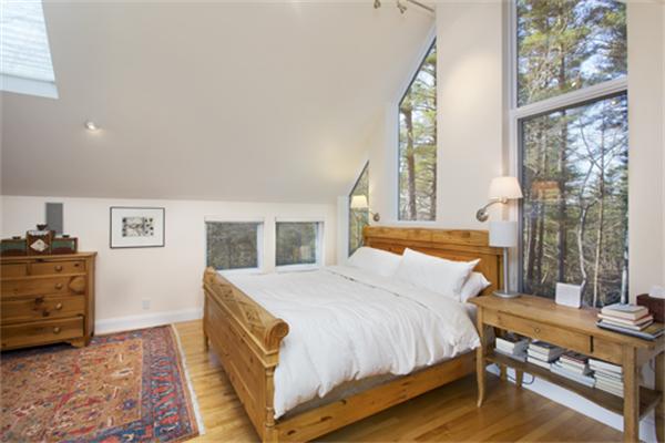 1 Revolutionary Road Concord, MA 01742 - Photo 8 of 12 a spacious bedroom with a bed and wooden floor