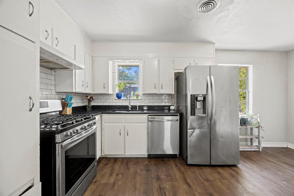 4812 Marshall Street Forest Hill, TX 76119 - Photo 5 of 10 a kitchen with a refrigerator sink and wooden floor