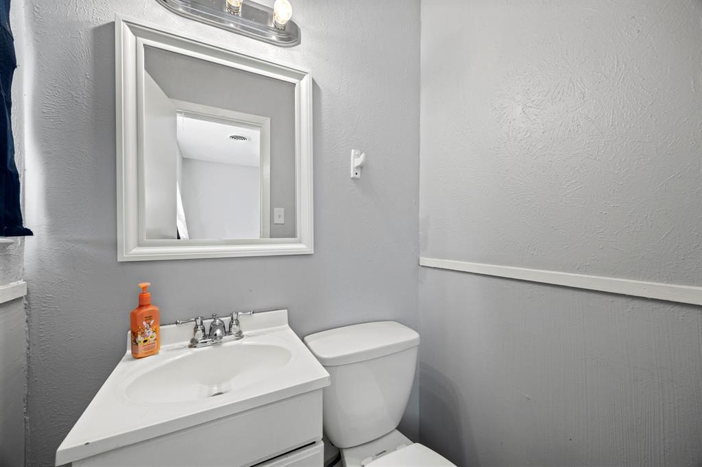 4812 Marshall Street Forest Hill, TX 76119 - Photo 10 of 10 a bathroom with a toilet sink and mirror