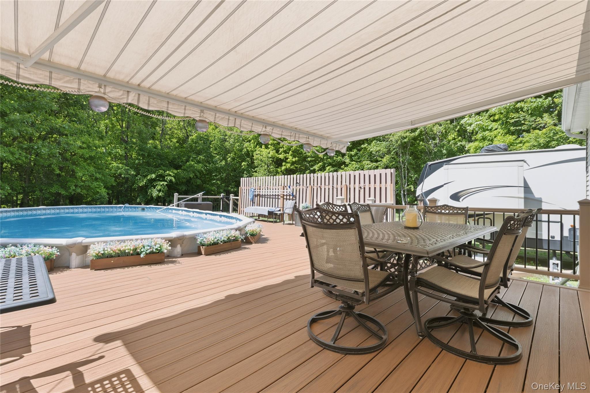 239-241 Fosler Road Highland, NY 12528 - Photo 20 of 42 Expansive outdoor entertaining area featuring a wood-finish deck, an above-ground swimming pool, and a white canvas awning
