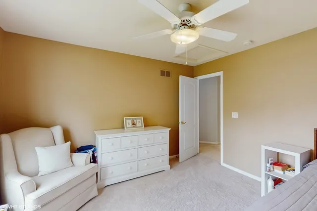 a living room with furniture and a baby crib