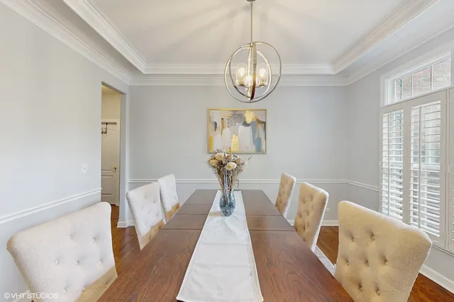a view of a dining room with furniture wooden floor and chandelier