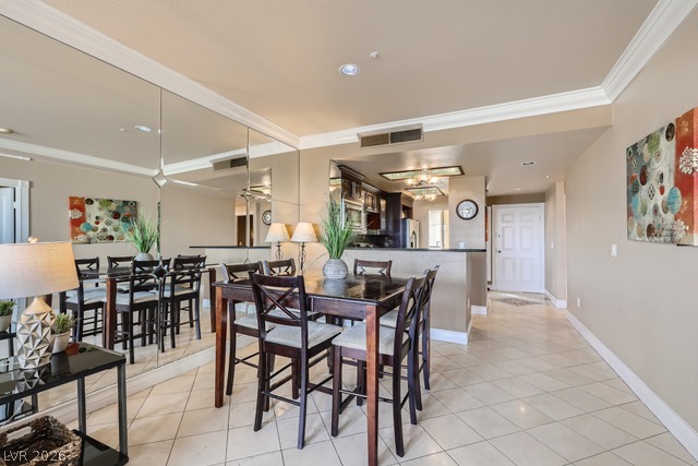 270 East Flamingo Road, Unit 315 Las Vegas, NV 89169 - Photo 4 of 11 The seamless flow between the dining and kitchen areas, accentuated by mirrored walls and crown molding, offers an airy feel.