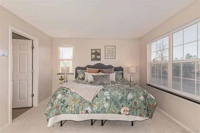 a spacious bedroom with a bed and a window