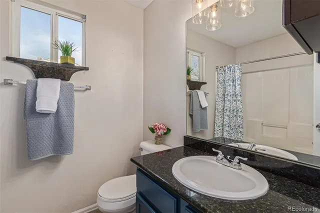 a view of a house with a yard covered in the forest