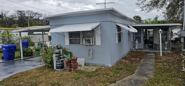 a backyard of a house with wooden fence and plants