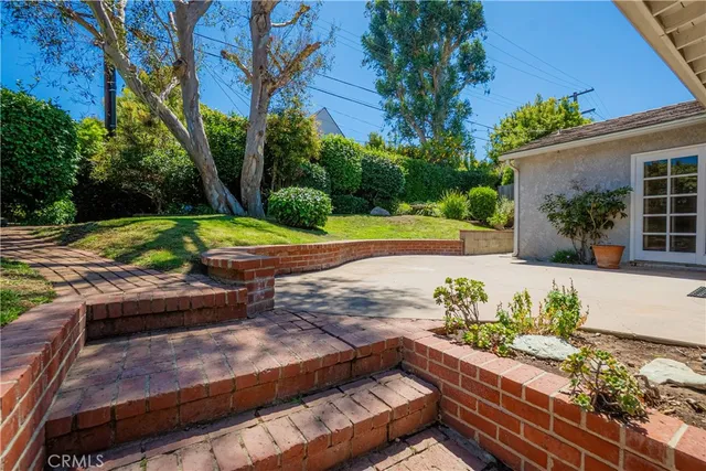 a kitchen with granite countertop cabinets stainless steel appliances a sink and a window