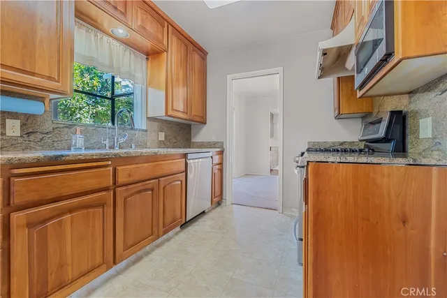 a large kitchen with a lot of cabinets and a wooden floor