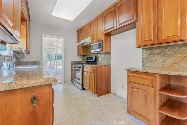 a view of an empty room with glass door and balcony