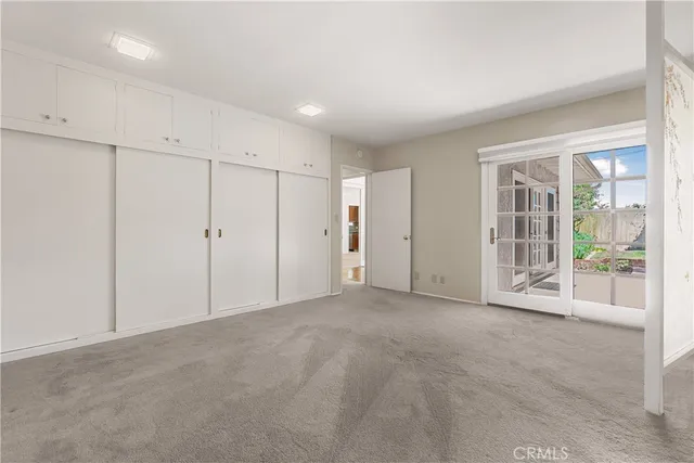 an empty room with closet area