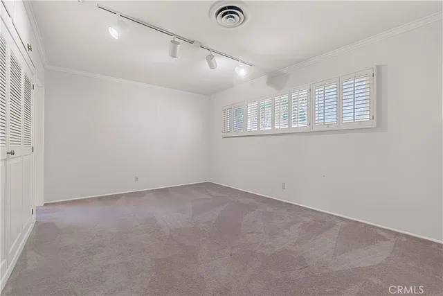an empty room with windows and closet