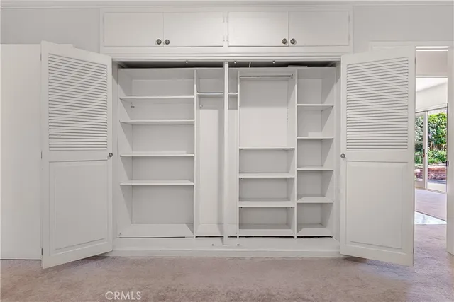 a view of an empty room with cabinet and stairs