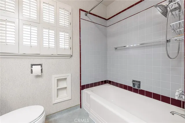 a view of a backyard with plants and palm trees