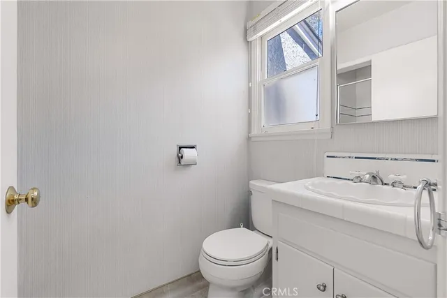 a view of a lake with a bench and trees