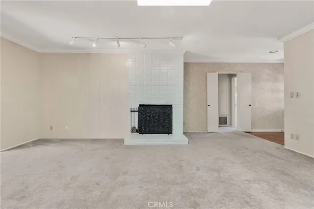 a view of an empty room with a fireplace