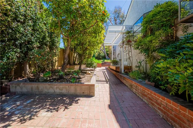 aerial view of a house with a yard and potted plants