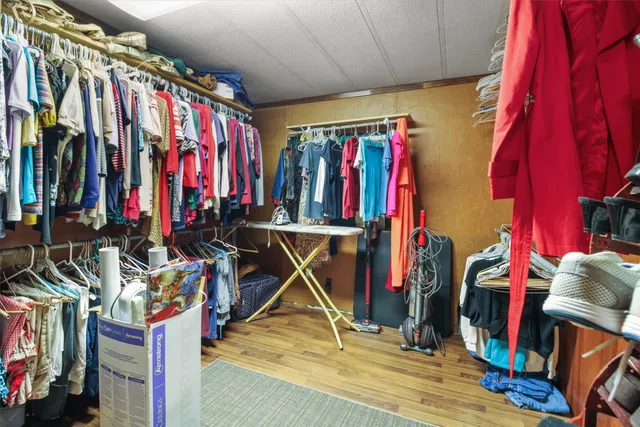 a view of walk in closet with clothes