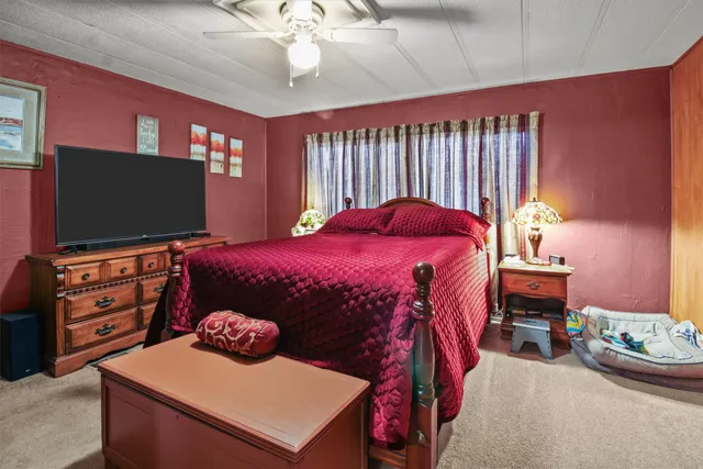 a bedroom with a bed and flat screen tv