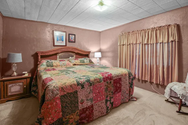 a bedroom with a bed and a lamp