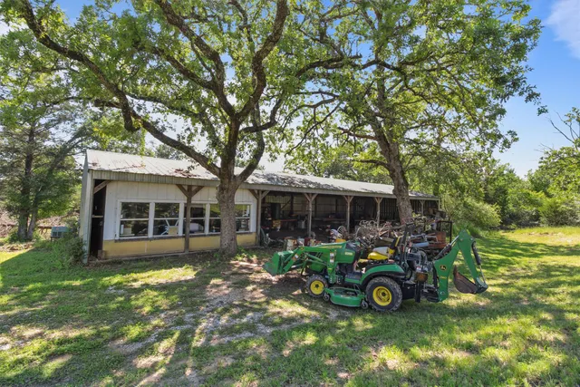 an aerial view of a house with a yard and lake view