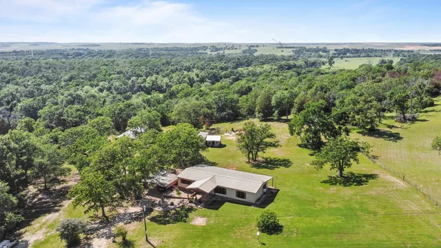 an aerial view of a house with a yard