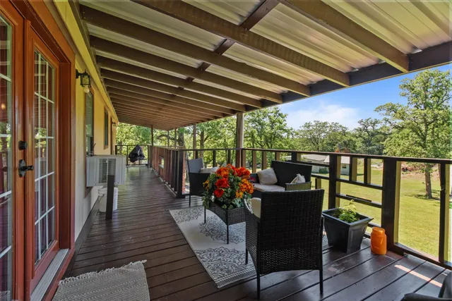 a view of a chairs and table in the balcony